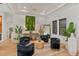 Chic living room with black accent chairs, elegant decor, and natural light at 10416 Pocket Ln, Orlando, FL 32836