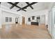 A modern open-concept with tray ceiling, fireplace, living room, and kitchen dining area with access to a porch at 10416 Pocket Ln, Orlando, FL 32836
