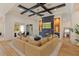 Cozy living room with fireplace, statement ceiling, and sliding glass doors to patio at 10416 Pocket Ln, Orlando, FL 32836