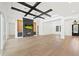 An open-concept living room with tray ceiling, fireplace, and access to a dining area and covered porch at 10416 Pocket Ln, Orlando, FL 32836