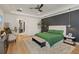 Beautifully staged main bedroom with accent wall and ensuite bathroom at 10416 Pocket Ln, Orlando, FL 32836