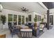 Inviting outdoor living area with comfortable seating, ceiling fan, and access to the home's interior at 10416 Pocket Ln, Orlando, FL 32836