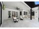 Covered patio with outdoor seating and lounge area perfect for entertaining at 10416 Pocket Ln, Orlando, FL 32836