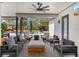 Covered patio featuring stylish seating, ceiling fan, and views of the backyard pool at 10416 Pocket Ln, Orlando, FL 32836