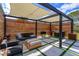 Outdoor pergola area featuring a built-in grill, seating area, and privacy screens at 10416 Pocket Ln, Orlando, FL 32836