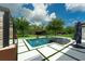 Stunning pool and backyard with modern tile design and lush greenery at 10416 Pocket Ln, Orlando, FL 32836