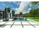 Expansive pool area with lush lawn and contemporary design elements at 10416 Pocket Ln, Orlando, FL 32836