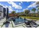 Stunning backyard pool with water features, lounge chairs, and a pergola with outdoor seating area at 10416 Pocket Ln, Orlando, FL 32836