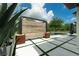 Modern pool area with stylish wood screen, sleek tiles, and lush landscaping at 10416 Pocket Ln, Orlando, FL 32836