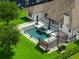 An aerial shot showcases the pool, outdoor living space and pristine landscaping of this exceptional property at 10416 Pocket Ln, Orlando, FL 32836
