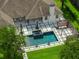 Aerial view of backyard pool and patio including lounge seating, and lush landscaping, providing a private oasis at 10416 Pocket Ln, Orlando, FL 32836