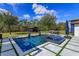 Beautiful backyard pool with a jacuzzi, water features, and a view of the backyard and wooded area at 10416 Pocket Ln, Orlando, FL 32836