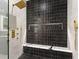 Modern glass enclosed shower featuring dual shower heads, a shower bench, and decorative tile at 10416 Pocket Ln, Orlando, FL 32836