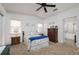 Bright bedroom with double bed, dresser, and ensuite bathroom access at 1207 Palmetto Dr, Lady Lake, FL 32159
