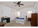 Cozy bedroom with double bed, dresser, and ceiling fan at 1207 Palmetto Dr, Lady Lake, FL 32159