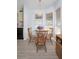 Small dining area with a glass-top table and four wooden chairs at 1207 Palmetto Dr, Lady Lake, FL 32159