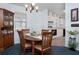 Spacious dining area with kitchen view, and wooden table set at 1207 Palmetto Dr, Lady Lake, FL 32159