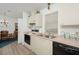 Efficient kitchen with light cabinets, pink countertops, and stainless steel appliances at 1207 Palmetto Dr, Lady Lake, FL 32159