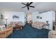 Spacious living room with blue carpet and neutral colored furniture at 1207 Palmetto Dr, Lady Lake, FL 32159