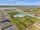 Aerial view of community pool, playground, and homes with solar panels at 1231 Citrus Landings Blvd, Davenport, FL 33837