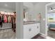 Double vanity bathroom with granite countertop and walk-in closet access at 1231 Citrus Landings Blvd, Davenport, FL 33837