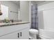 Updated bathroom featuring a shower/tub, granite countertop, and white cabinets at 1231 Citrus Landings Blvd, Davenport, FL 33837