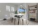Modern dining area with white table and chairs, and large window at 1231 Citrus Landings Blvd, Davenport, FL 33837