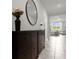 Inviting entryway with two dark brown storage cabinets and view to living room at 1231 Citrus Landings Blvd, Davenport, FL 33837