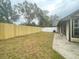 Large backyard with a wooden fence and patio area at 12703 Whiterapids Dr, Orlando, FL 32828