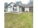 Front view of a single story house with a spacious yard at 12703 Whiterapids Dr, Orlando, FL 32828