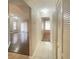 Clean and bright hallway with tile flooring and linen closet at 12703 Whiterapids Dr, Orlando, FL 32828