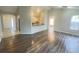 Open living room with new flooring and kitchen view at 12703 Whiterapids Dr, Orlando, FL 32828