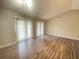 Spacious living room with wood-look floors and access to the backyard at 12703 Whiterapids Dr, Orlando, FL 32828