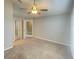 Main bedroom with ceiling fan and mirrored closet doors at 12703 Whiterapids Dr, Orlando, FL 32828