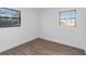 Bright bedroom with hardwood floors and two windows at 137 Scott Dr, Sanford, FL 32771