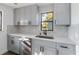 Modern kitchen with gray cabinets and a mosaic backsplash at 137 Scott Dr, Sanford, FL 32771