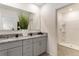 Double vanity bathroom with granite countertops and a large walk-in shower at 1527 Isleta Loop, Kissimmee, FL 34741