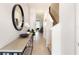 Bright and airy entryway with a modern console table and large mirror at 1527 Isleta Loop, Kissimmee, FL 34741