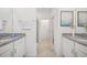 Double vanity bathroom with granite countertop and a shower at 1688 Blue Lagoon Cir, Mascotte, FL 34753