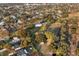 Stunning aerial view of country estate with green lawn and wooded borders at 1730 Connecticut Ave, St Cloud, FL 34769