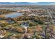 Expansive aerial view of a luxury home with a pool, lush greenery, and neighborhood pond at 1730 Connecticut Ave, St Cloud, FL 34769