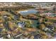 Aerial view of sprawling property with pond, mature trees, and neighboring homes at 1730 Connecticut Ave, St Cloud, FL 34769