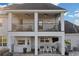 Covered back patio features multiple levels, ceiling fans, and ample seating for relaxing outdoors at 1730 Connecticut Ave, St Cloud, FL 34769