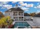 Beautiful pool and outdoor living space with multiple seating areas and lush landscaping at 1730 Connecticut Ave, St Cloud, FL 34769