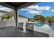 Relaxing view of the pool and backyard from a shaded patio with comfortable outdoor furniture at 1730 Connecticut Ave, St Cloud, FL 34769