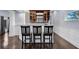 Cozy bar area features wooden cabinets, a granite countertop, and comfortable bar stool seating at 1730 Connecticut Ave, St Cloud, FL 34769