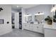 Spacious bathroom with double sinks, modern fixtures, and a large walk-in shower with updated tiling at 1730 Connecticut Ave, St Cloud, FL 34769