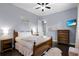 Inviting bedroom features dark wood floors, two nightstands, soft decor and a mounted television at 1730 Connecticut Ave, St Cloud, FL 34769