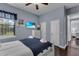 Bright bedroom with light walls, television, and a glimpse into the ensuite bathroom at 1730 Connecticut Ave, St Cloud, FL 34769
