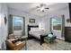 Bedroom with hardwood floors, two windows, and chairs at 1730 Connecticut Ave, St Cloud, FL 34769
